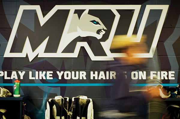 One of the Mount Royal Cougars' logos painted on a wall. Beneath it the words Play like your hair is on fire is painted.