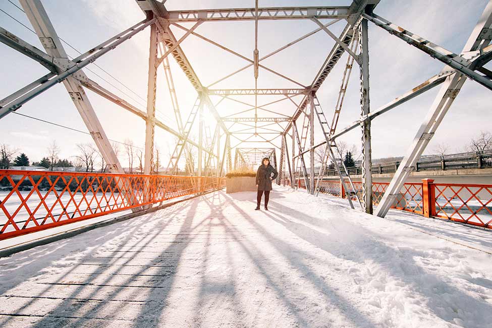 Sheila Connell framed by a bridge in Calgary