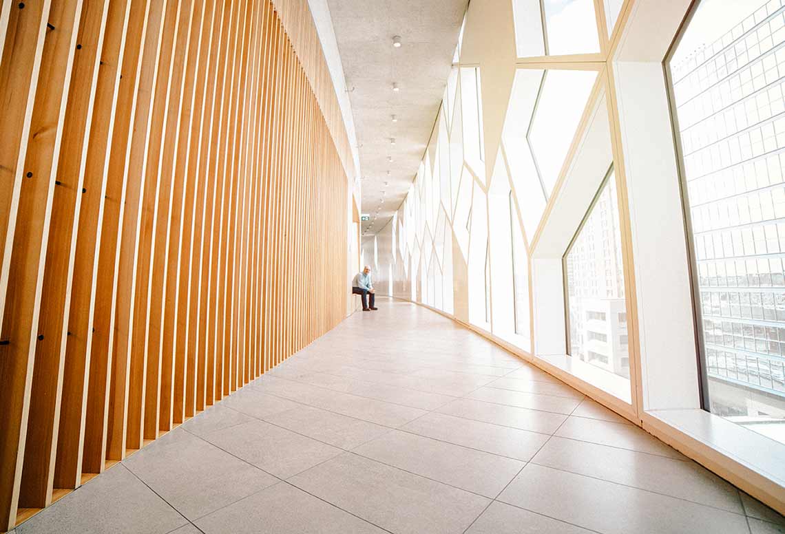 James Bergeron sitting onthe side of a ramp in the Central Calgary Public Library