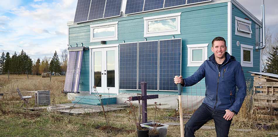Kenton Zerbin in front of his tiny home outside of Edmonton
