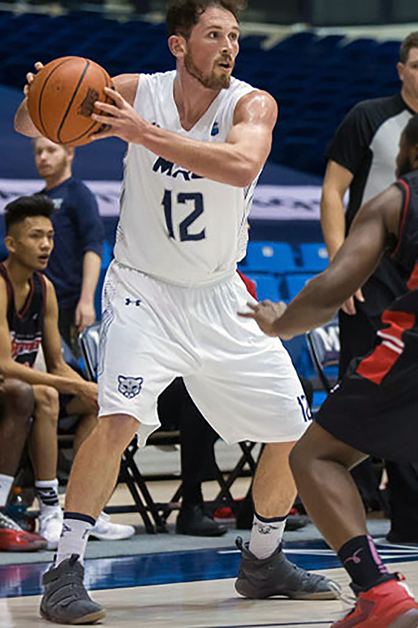 Noah Lewis playing a game while a member of the MRU Cougars men's basketball team