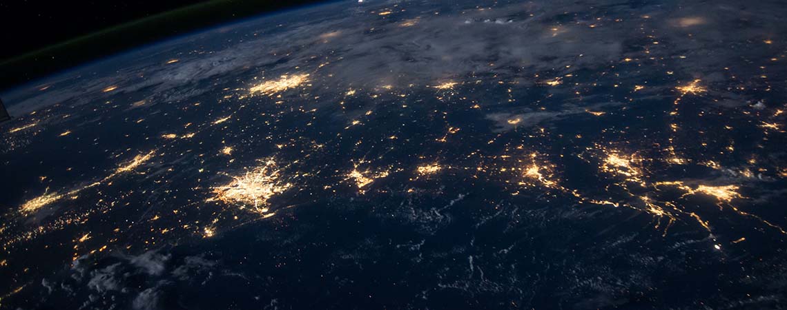 Image of the Earth from space at night. Cities are lit up by their light usage.