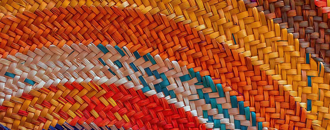 Close up of a colourful woven hat.
