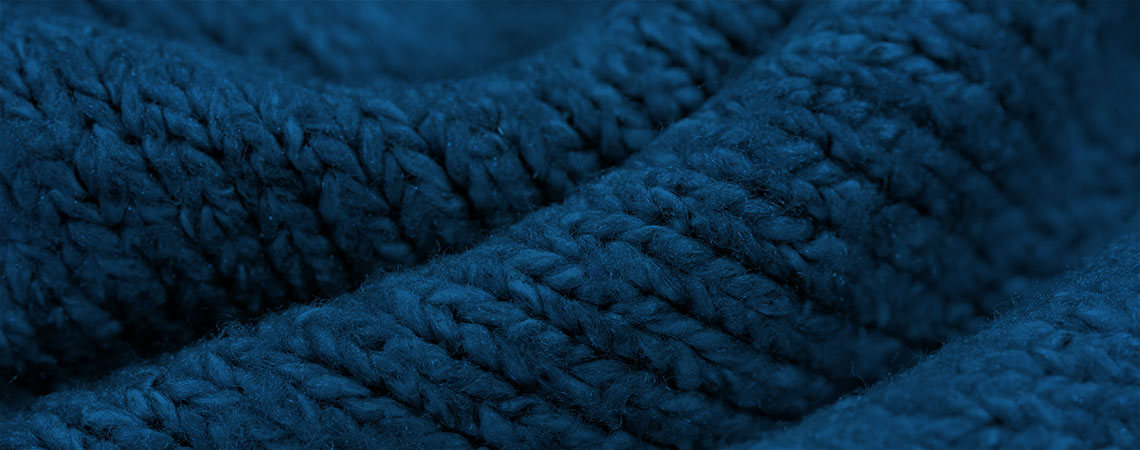 Close up photo of a knit blanket.