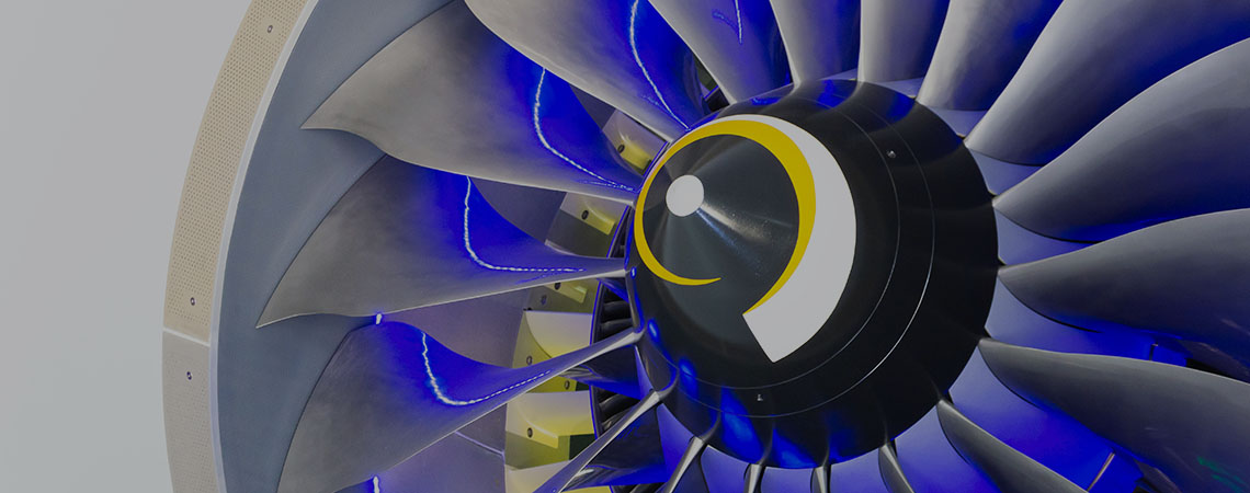 Cose up photo of a blue and yellow plane engine.