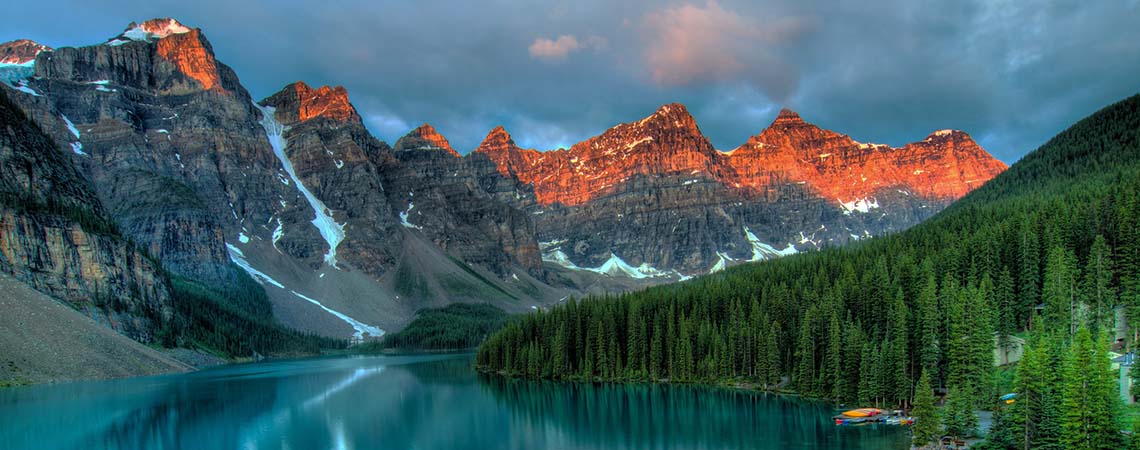 Photo of a lake framed by the Rocky Mountains.