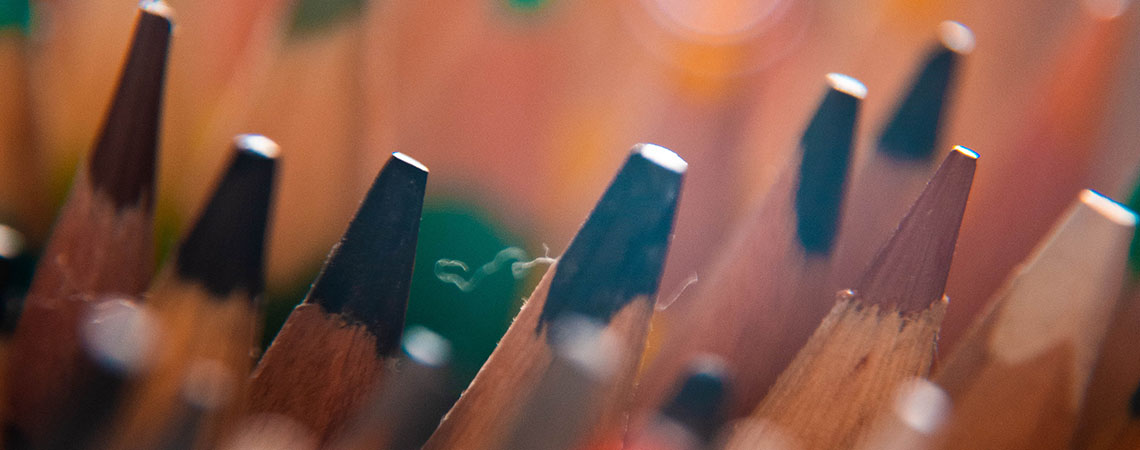 Close up photo of the tips of coloured pencils.