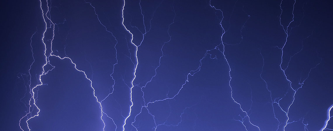 Bolts of lighting on an indigo sky.