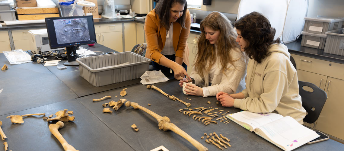 Dr. Rebecca Gilmour works with alumni assistant Jessica King and and current student assistant Cerena Bond analyzing the remains of an ancient Roman skeleton.