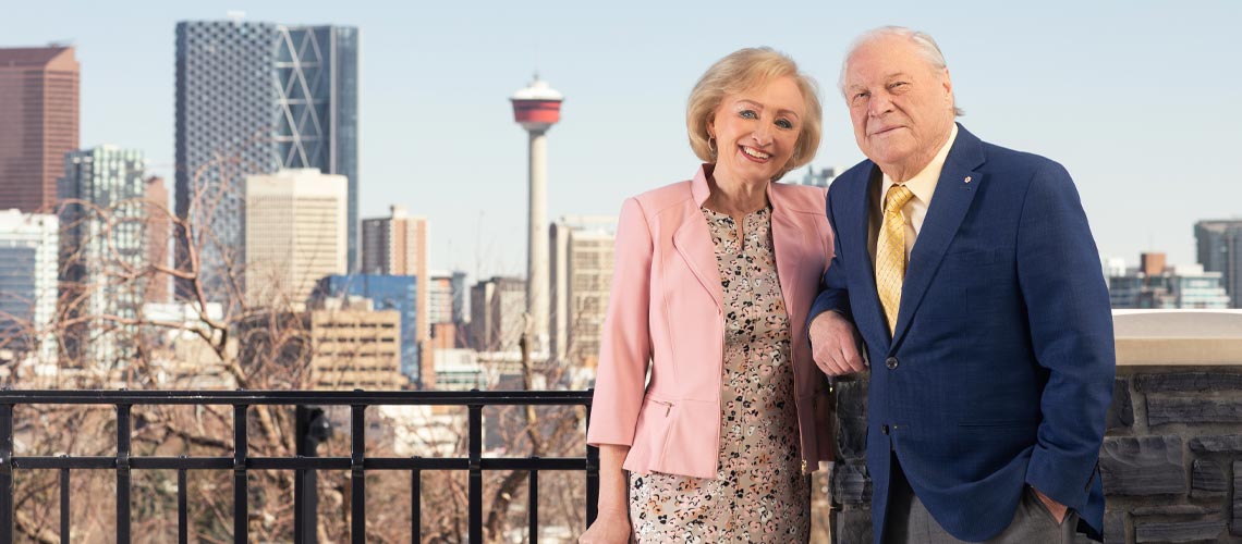 Don and Ruth Taylor standing side-by-side with the City of Calgary in the background.