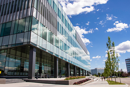 A modern looking building with concrete steps, walkways and garden boxes.