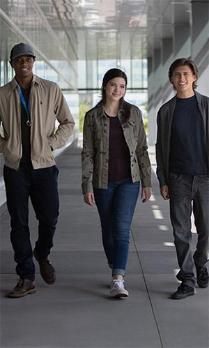 Photo of Heartland's Kataem O'Connor, Alisha Newton and Dempsey Bryk ourside Mount Royal University's Riddell Library and Learning Centre.