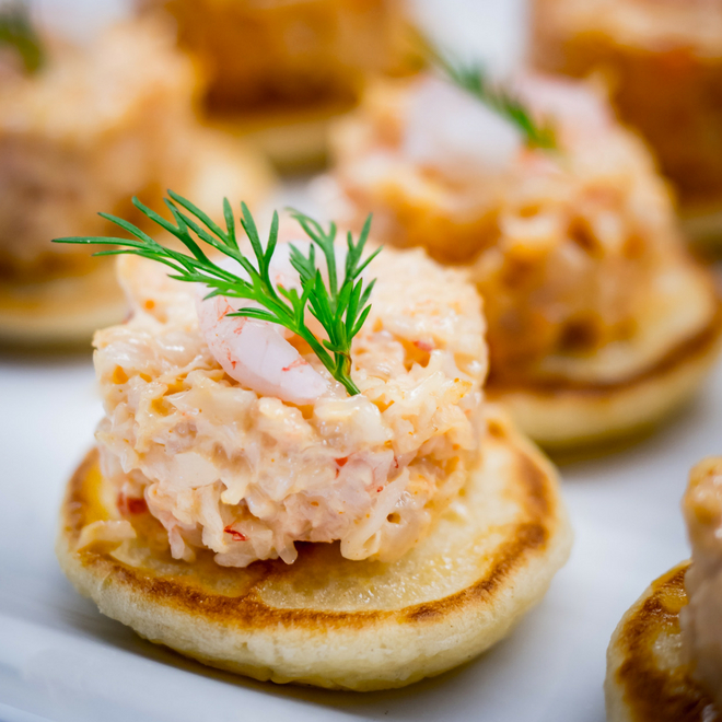 Close up photo of a crabcake on a cracker.