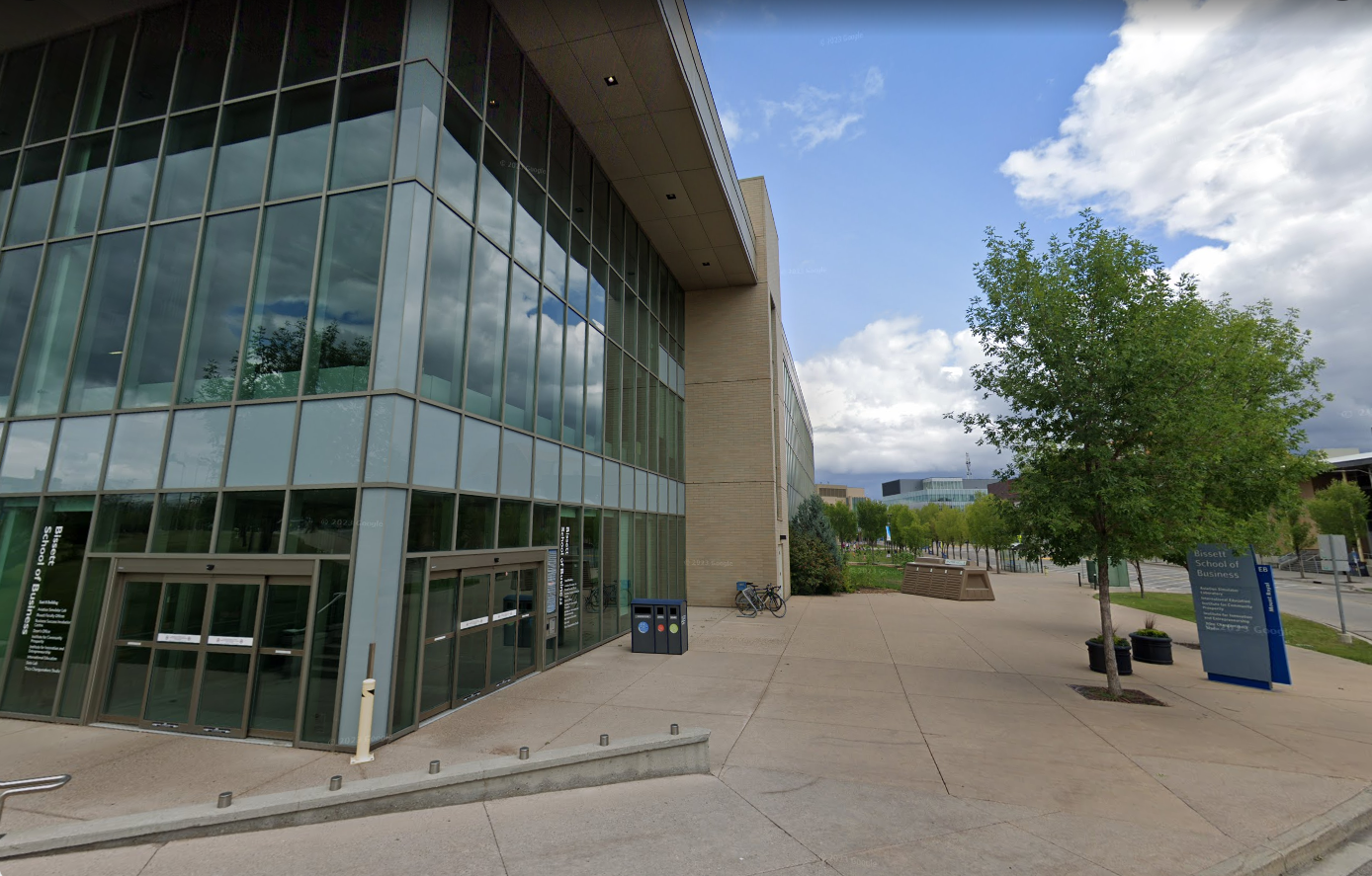 At the entrance to the Bissett School of Business (outside)