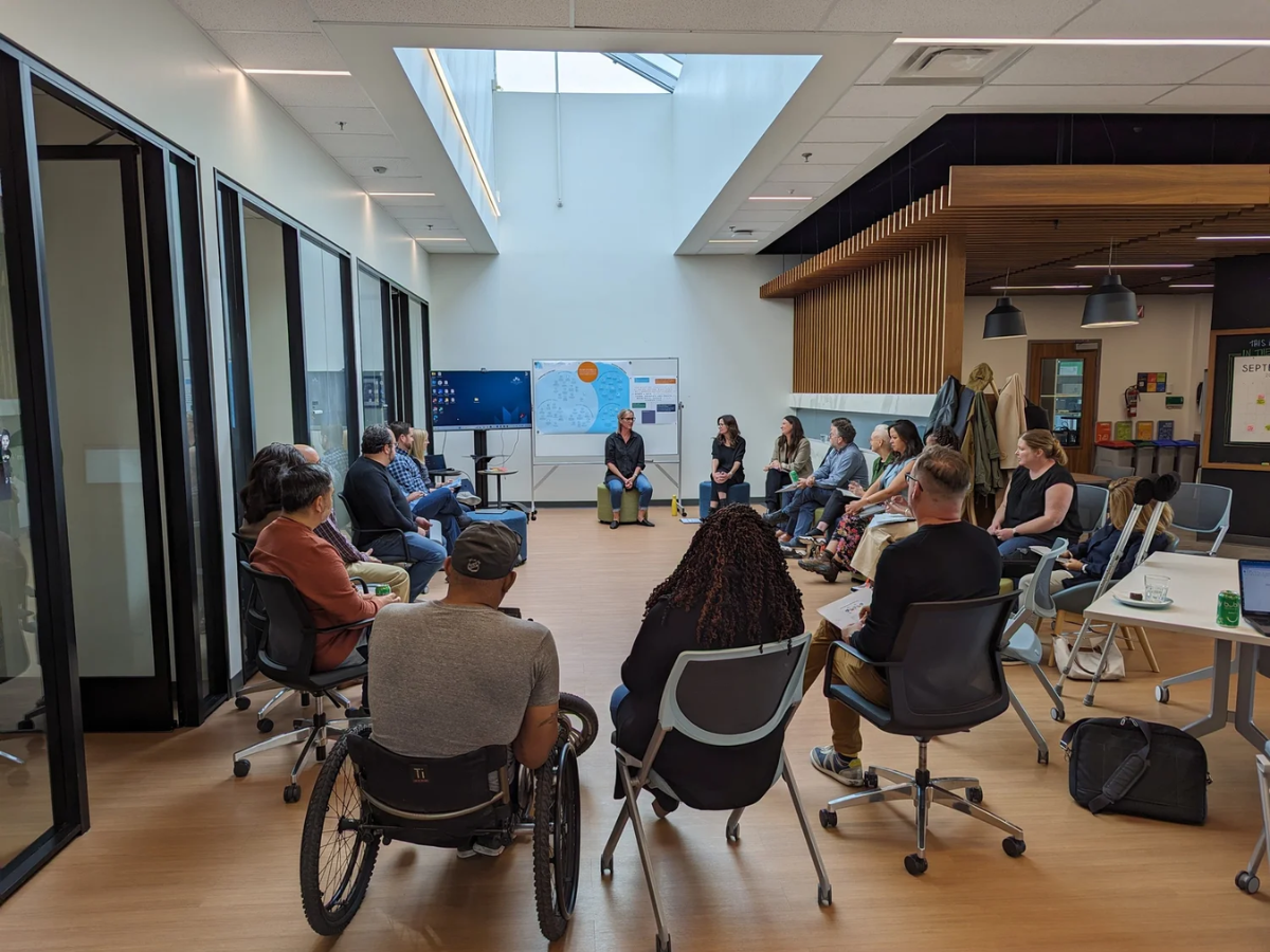 A group of diverse community members, including MRU students, community practitioners, and educators, gather in circles for a systems change workshop at the Trico Changemakers Studio
